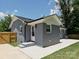 Newly renovated home exterior with brick, patio, and manicured lawn at 445 Short Hills Dr, Charlotte, NC 28217