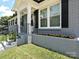 Close-up of the front porch, showing white columns, railings, and beautiful landscaping at 445 Short Hills Dr, Charlotte, NC 28217