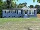 Charming single-story home featuring a gray brick facade and a welcoming front porch at 445 Short Hills Dr, Charlotte, NC 28217