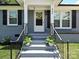 Inviting front porch with steps leading to the entrance and lovely potted plants at 445 Short Hills Dr, Charlotte, NC 28217