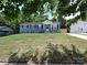 Charming grey brick home with black shutters, white trim, and a well-maintained front yard at 445 Short Hills Dr, Charlotte, NC 28217