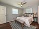 Serene main bedroom featuring a ceiling fan, windows, and modern furnishings at 445 Short Hills Dr, Charlotte, NC 28217