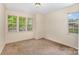 Bedroom featuring neutral carpet and three windows at 5301 Amity Springs Dr, Charlotte, NC 28212
