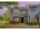 Charming two-story townhome with light gray siding and manicured landscaping provides a welcoming curb appeal at 5301 Amity Springs Dr, Charlotte, NC 28212