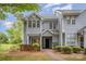 Charming two-story townhome with light gray siding and manicured landscaping provides a welcoming curb appeal at 5301 Amity Springs Dr, Charlotte, NC 28212
