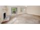 Spacious living room featuring a fireplace and sliding door access to the outdoors provides a relaxing atmosphere at 5301 Amity Springs Dr, Charlotte, NC 28212