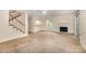 Open living area with fireplace, stairs, and kitchen pass-through enhance modern living and entertaining at 5301 Amity Springs Dr, Charlotte, NC 28212