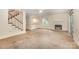 Open living area with fireplace, stairs, and kitchen pass-through enhance modern living and entertaining at 5301 Amity Springs Dr, Charlotte, NC 28212