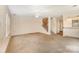 Spacious living area with a ceiling fan, stairs, and convenient passthrough to the kitchen enhances the home's functionality at 5301 Amity Springs Dr, Charlotte, NC 28212