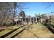 View of the screened in back porch, garden, and spacious backyard of this home at 544 Stoneybrook Rd, Statesville, NC 28677