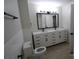 Updated bathroom featuring a double vanity, framed mirror, and tile surround at 544 Stoneybrook Rd, Statesville, NC 28677