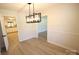 Bright dining room boasts modern light fixture, hardwood floors and neutral walls at 544 Stoneybrook Rd, Statesville, NC 28677