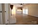 Open-concept living room features a white brick fireplace and wooden floors, leading to the back porch at 544 Stoneybrook Rd, Statesville, NC 28677