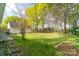 Spacious backyard featuring a shed, mature trees, and a well-manicured lawn at 5700 Carmel Station Ave, Charlotte, NC 28226