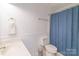 Bathroom with blue shower curtain, modern toilet and brushed nickel hardware at 5700 Carmel Station Ave, Charlotte, NC 28226