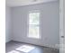 Simple bedroom with laminate floors, neutral walls, a bright window view at 5700 Carmel Station Ave, Charlotte, NC 28226