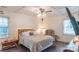 Comfortable bedroom with a ceiling fan, a large bed, and a window for natural light at 5700 Carmel Station Ave, Charlotte, NC 28226