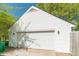 Detached two-car garage with white siding and well-maintained door at 5700 Carmel Station Ave, Charlotte, NC 28226
