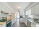 Well-lit kitchen featuring white cabinetry, stainless steel appliances, and hardwood countertops at 5700 Carmel Station Ave, Charlotte, NC 28226