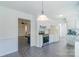 Bright, open kitchen featuring white cabinetry, stainless steel appliances, and tile floors at 5700 Carmel Station Ave, Charlotte, NC 28226
