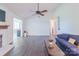 Spacious living room with hardwood floors, ceiling fan, and bright natural light at 5700 Carmel Station Ave, Charlotte, NC 28226
