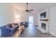 Inviting living room with hardwood floors, ceiling fan, fireplace, and comfortable seating at 5700 Carmel Station Ave, Charlotte, NC 28226