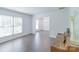 Bright living room with hardwood floors, windows, and view into the dining room at 5700 Carmel Station Ave, Charlotte, NC 28226