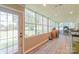 Bright sunroom with many windows offering natural light and view to fenced backyard at 5700 Carmel Station Ave, Charlotte, NC 28226