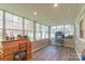 Sunroom with tile floors and surrounded by large windows offering views of the backyard at 5700 Carmel Station Ave, Charlotte, NC 28226