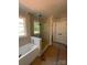 Modern bathroom featuring a glass-enclosed shower and a luxurious soaking tub at 5947 Tipperary Dr, Denver, NC 28037