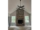 Cozy living room featuring a floor-to-ceiling stone fireplace and a ceiling fan at 5947 Tipperary Dr, Denver, NC 28037