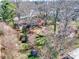 A birds-eye view of the house from above surrounded by a wooded lot with many trees at 601 Wilmar Nw St, Concord, NC 28025