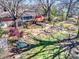Aerial view of a landscaped backyard with patio, mature trees, and lush greenery at 601 Wilmar Nw St, Concord, NC 28025