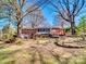 A lovely backyard includes patio, green lawn, mature trees, and serene plantings at 601 Wilmar Nw St, Concord, NC 28025