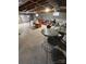 Large, unfinished basement area with table and chairset, exposed ceiling, and room for storage at 601 Wilmar Nw St, Concord, NC 28025