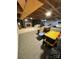 A finished basement featuring carpeting, brick fireplace, and exposed ceiling and structural beams at 601 Wilmar Nw St, Concord, NC 28025