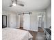 This bedroom includes a barn door closet and attached bathroom, offering convenience and style at 601 Wilmar Nw St, Concord, NC 28025