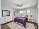 Cozy bedroom featuring hardwood floors, white trim, and a soft rug at 601 Wilmar Nw St, Concord, NC 28025