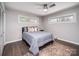 Comfortable bedroom features hardwood floors, neutral walls, ceiling fan and bright, natural light from two large windows at 601 Wilmar Nw St, Concord, NC 28025