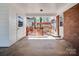 View of the rear carport of a brick home leading to an outdoor deck area for entertaining guests at 601 Wilmar Nw St, Concord, NC 28025