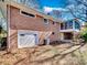 Brick exterior showcasing a garage and screened porch, providing outdoor living and curb appeal at 601 Wilmar Nw St, Concord, NC 28025