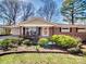 Classic brick home with a cozy front porch and lush landscaping at 601 Wilmar Nw St, Concord, NC 28025