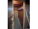 A storage room or closet under the stairs with a single shelf for storing paints and home repair products at 601 Wilmar Nw St, Concord, NC 28025