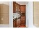 Elegant bar area featuring custom wood cabinetry, wine storage, and a convenient sink at 7295 Three Sisters Ln, Concord, NC 28027