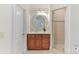 Well-lit bathroom with a single sink vanity, decorative mirror, and glass-enclosed shower stall at 7295 Three Sisters Ln, Concord, NC 28027