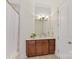 Cozy bathroom featuring warm wooden vanity and classic fixtures at 7295 Three Sisters Ln, Concord, NC 28027