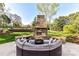 Inviting outdoor fire pit area with built-in seating, perfect for entertaining or enjoying cozy evenings at 7295 Three Sisters Ln, Concord, NC 28027