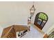 Grand foyer with a curved wood front door, chandelier, staircase, and tile flooring at 7295 Three Sisters Ln, Concord, NC 28027