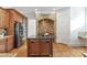 Gourmet kitchen with stainless steel appliances, center island, and brick alcove at 7295 Three Sisters Ln, Concord, NC 28027