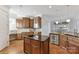 Spacious kitchen with wooden cabinets, stainless steel appliances, and island at 7295 Three Sisters Ln, Concord, NC 28027